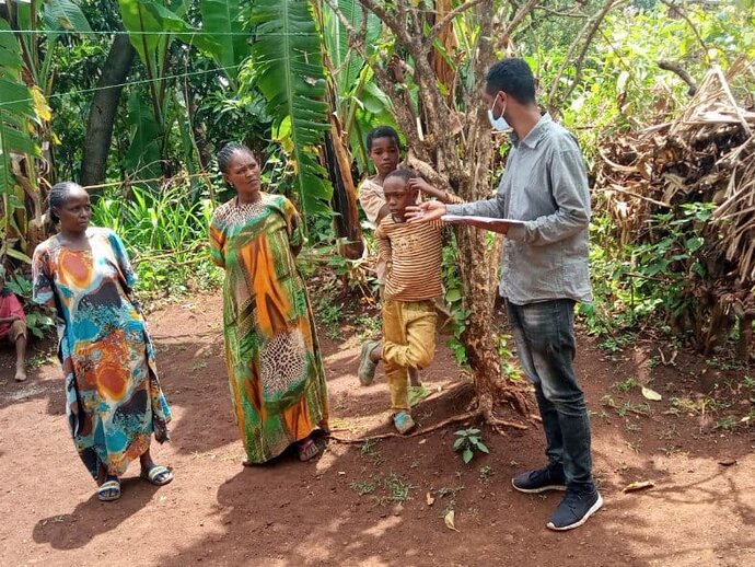 Habtamu Bedasa, a Zonal NTDs Technical Advisor with FHF, uses the Supervisors Coverage Tool (SCT) to assess the level of MDA coverage in a village in Ethiopia. (photo credit: Habtamu Bedasa)