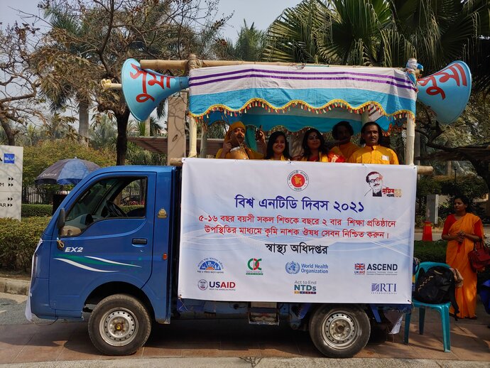 A folk band rides on the back of a truck playing music as part of World NTD Day celebrations
