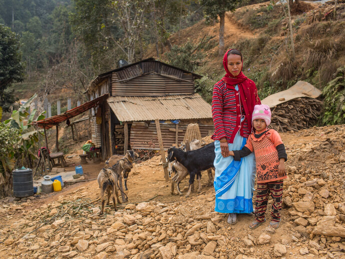 A female community health volunteer (FCHV), with her daughter in front of their home. Photo by Nabin Baral for RTI International