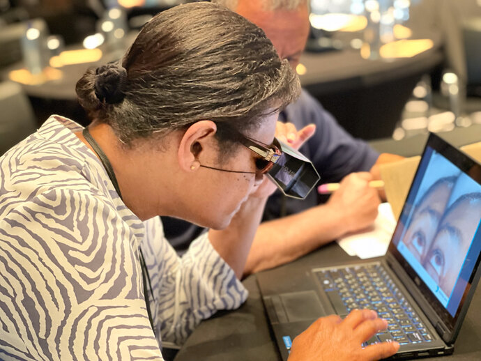 A participant at our July 2023 training event practices assessing eyes for trachoma using the photo-based curriculum. 