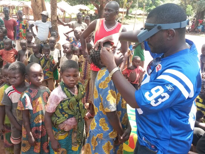 Children queue to have their eyes examined for trachoma. 