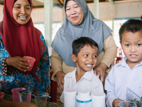 Students in Indonesia receive medicine during the national NTD campaign. 