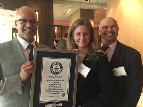 From left, Paul Weisenfeld and Lisa Rotondo of RTI and Aryc Mosher of USAID hold the Guinness World Record certificate.