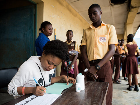 Students receive medicines during an NTD treatment campaign in Nigeria. 