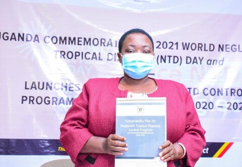 Uganda: the Honorable Minister of State for Health, Hon. Rhobinah Nabbanja holds the newly launched Sustainability Plan for Neglected Tropical Diseases