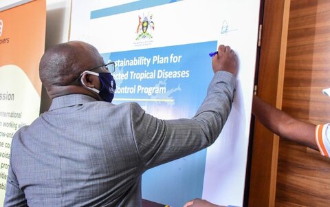 Dr. Alfred Mubangizi, Ag. Asst. Commissioner for Vector Borne and NTDs Division at the Uganda Ministry of Health signs the sustainability plan the launch on February 4, 2021. 