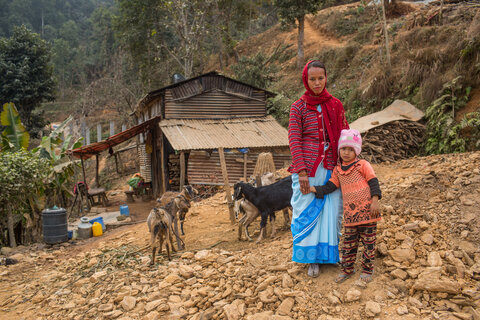 A female community health volunteer (FCHV), with her daughter in front of their home. Photo by Nabin Baral for RTI International