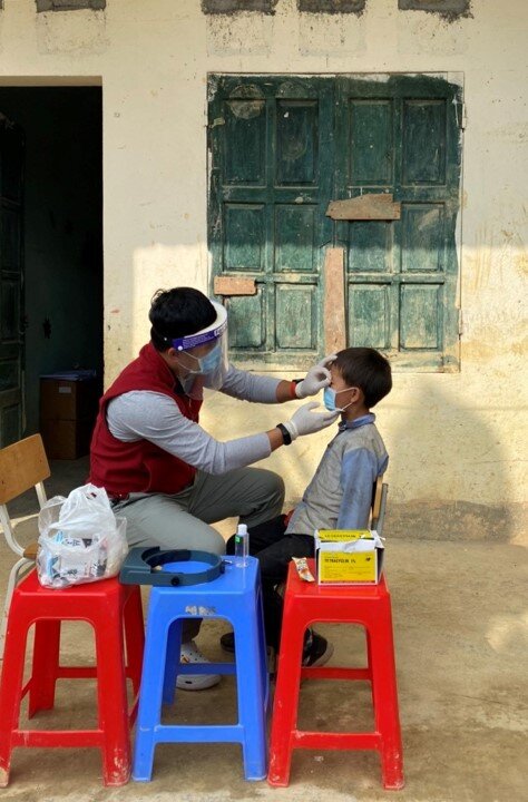 A child has their eyes examined for trachoma during a survey in Vietnam. 