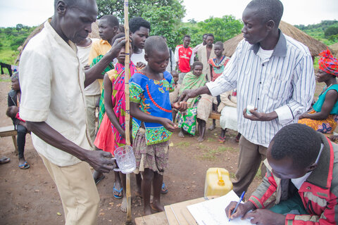 A community receives treatment for onchocerciasis in Uganda. 