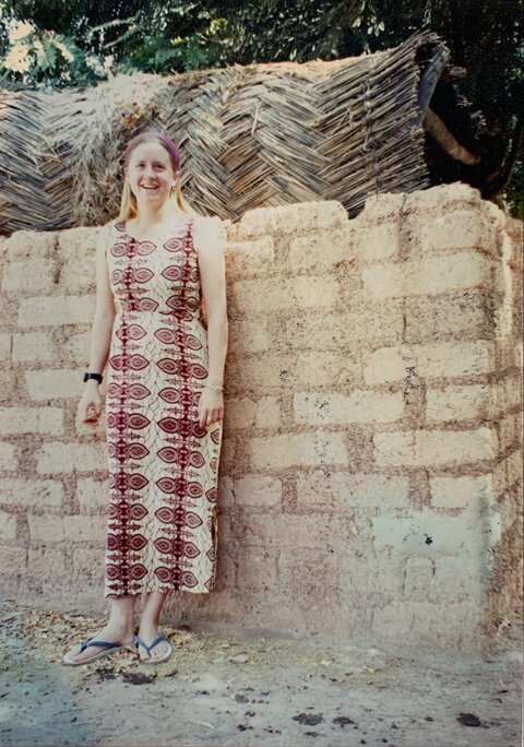 Lisa Rotondo stands in front of a doorway in Burkina Faso during her time as a Peace Corps Volunteer