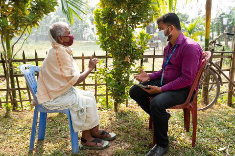 Menu Bala talks with a health worker about her condition and care. Photo credit: RTI International/ Abir Abdullah