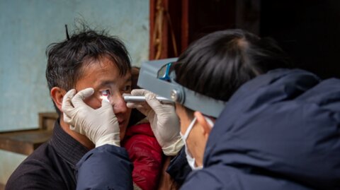 A local resident has his eyes examined by an ophthalmologist from Ha Giang Eye Hospital, Dr. Ninh Van Hien. Photo: The Fred Hollows Foundation. ​