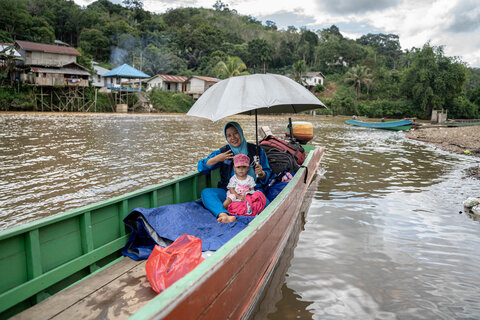 A midwife travels to join a lymphatic filiariasis survey in Nanga Ora village. Photo credit: RTI International, Oscar Siagian