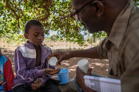 A child receives treatment for LF during a mass treatment campaign in Kilwa, Tanzania. Photo credit: RTI International/Roshni Lodhia