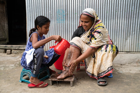 A woman with lymphedema was her leg with the help of her daughter, this is part of her ongoing care. Photo credit: RTI International/ Abir Abdullah