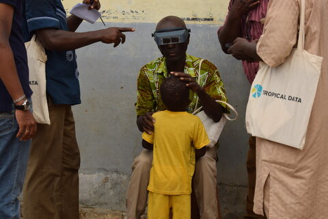 A trachoma grader assesses the eyes of a child during a Tropical Data global training of trainers event in Senegal, 2017. Photo Credit: RTI International/Shea Flynn