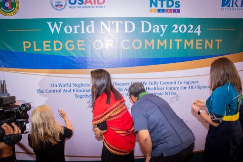 Representatives sign the wall of commitment during the World NTD Day 2024 celebration in Manila, Philippines. Photo credit: U.S. Embassy in the Philippines
