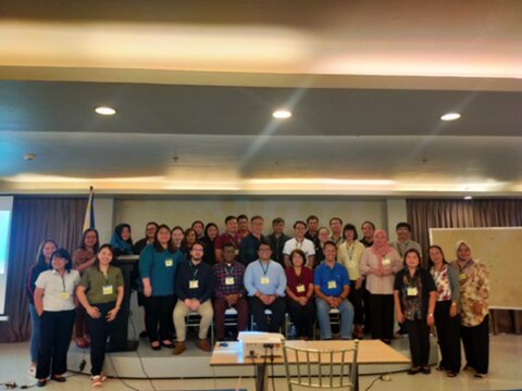 Program implementation review and financing workshop participants pose for a photo in Tacloban City, Philippines. Photo credit: Camille Baladjay/RTI International.   